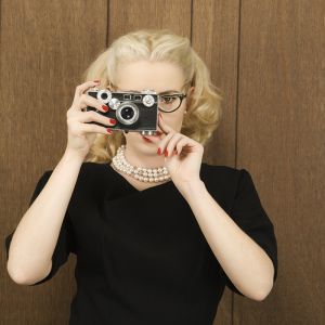 [826934_woman_holding_a_vintage_camera_up_to_her_face_.jpg]