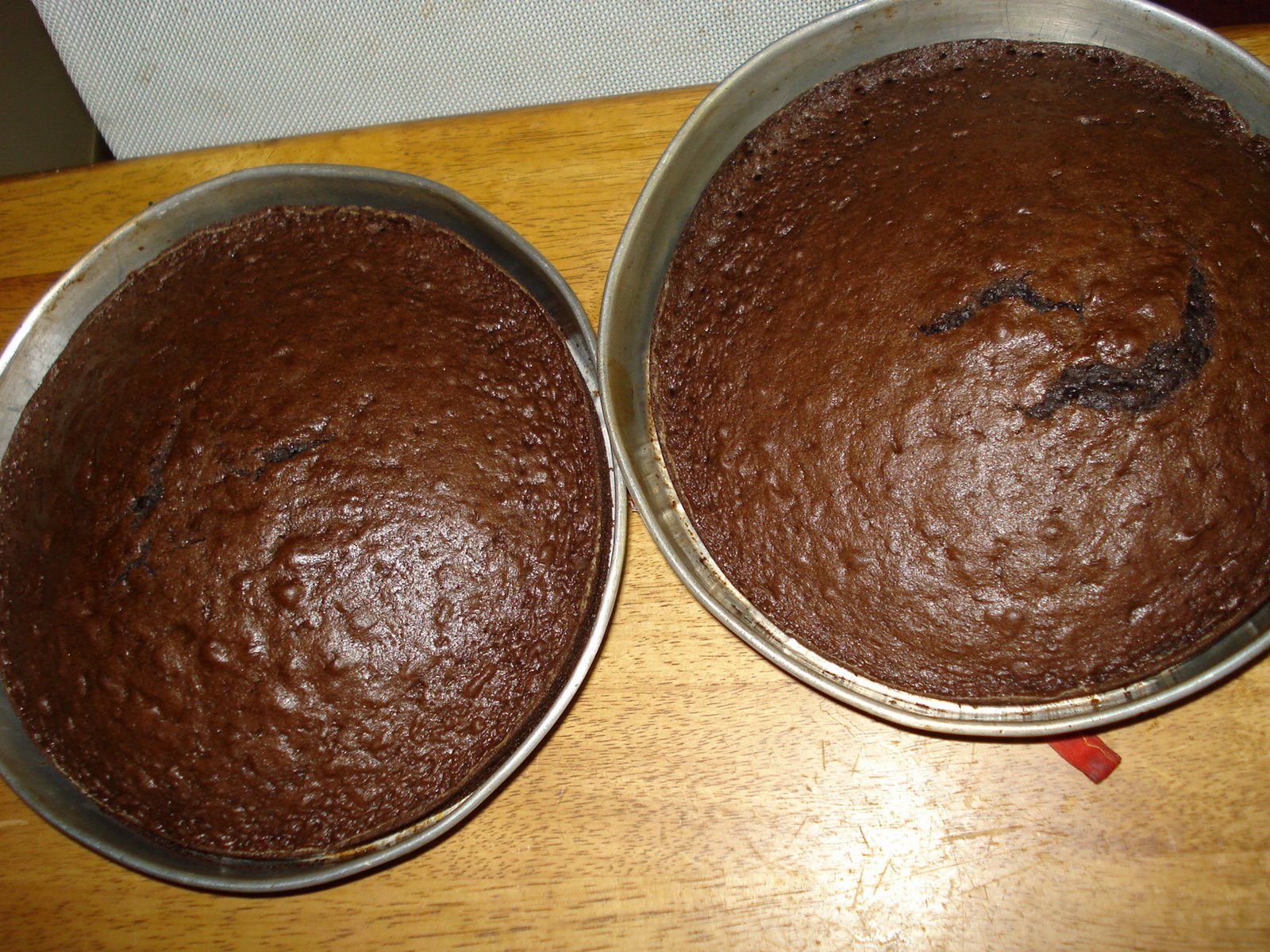 two 9x9 chocolate cakes cooling