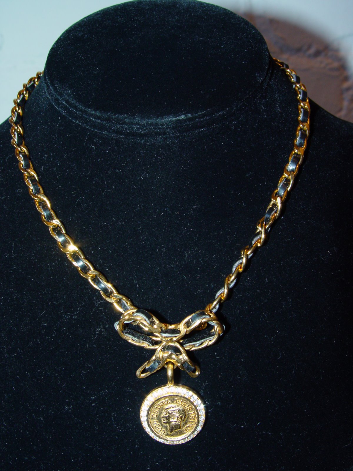 [CHANEL+CHAIN+AND+LEATHER+WEOVEN+NECKLACE+TO+BOW+WITH+CHANEL+SILHOUETTE+COIN+SURROUNDED+BY+RHINESTONES+1996+SPRING.JPG.JPG]
