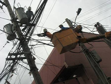 Meralco repair crew on a utility pole