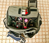 a bag with camera lenses and other objects inside