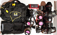 a group of camera bags and lenses