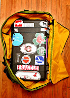 a black suitcase with stickers inside of it