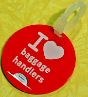 a red luggage tag with white text