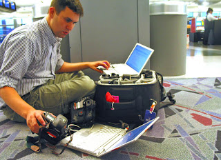 a man sitting on the floor with a laptop