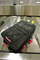 a black suitcase on a metal floor