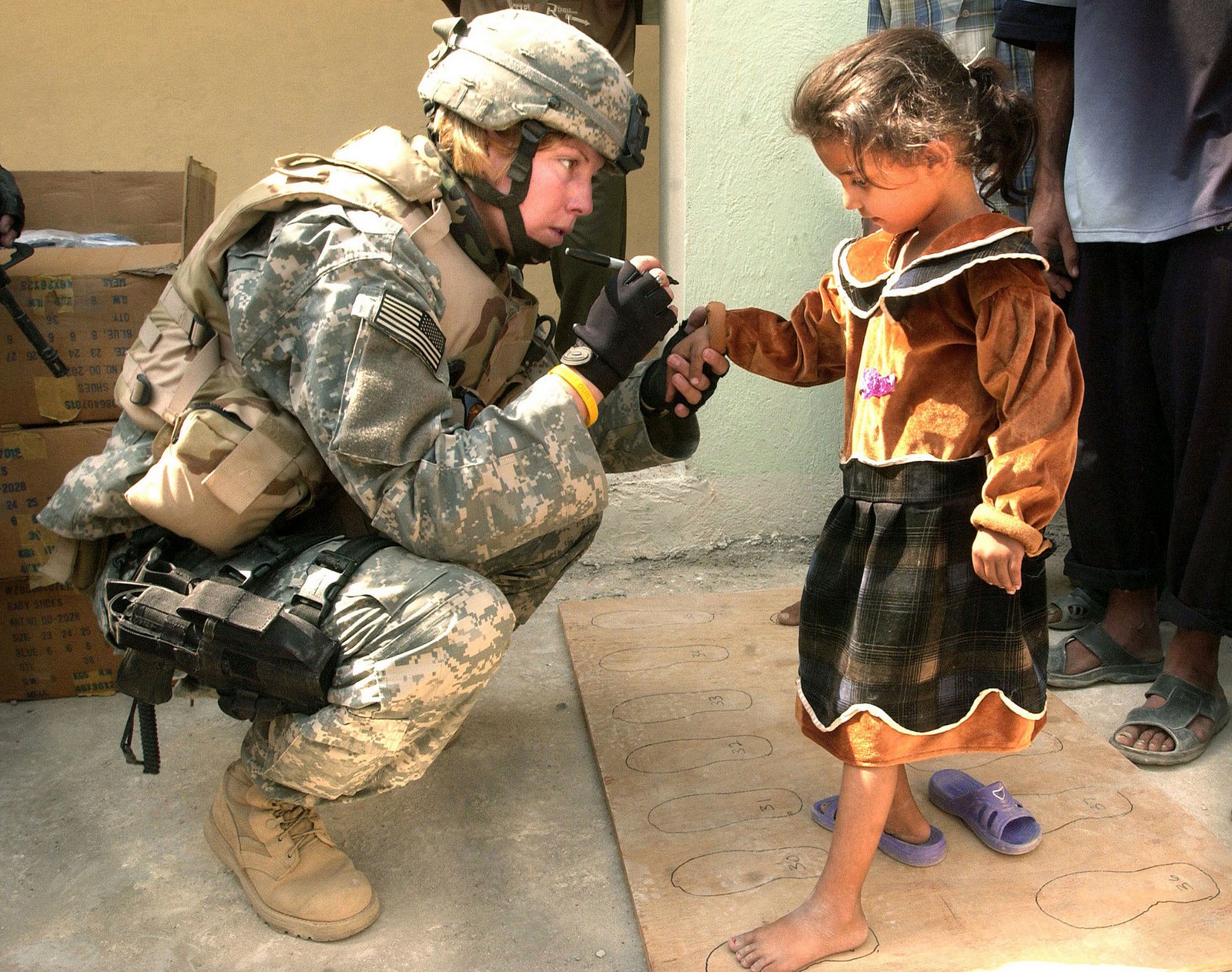 [An+Iraqi+girl+gets+her+feet+measured+for+a+new+pair+of+shoes.+U.S.+soldiers+assigned+to+B+Company,+448th+Civil+Affairs+Battalion,+gave+away+shoes+in+an+Al+Nafees+primary+school+in+Al+Kafajyeh,+Baghdad.jpg]