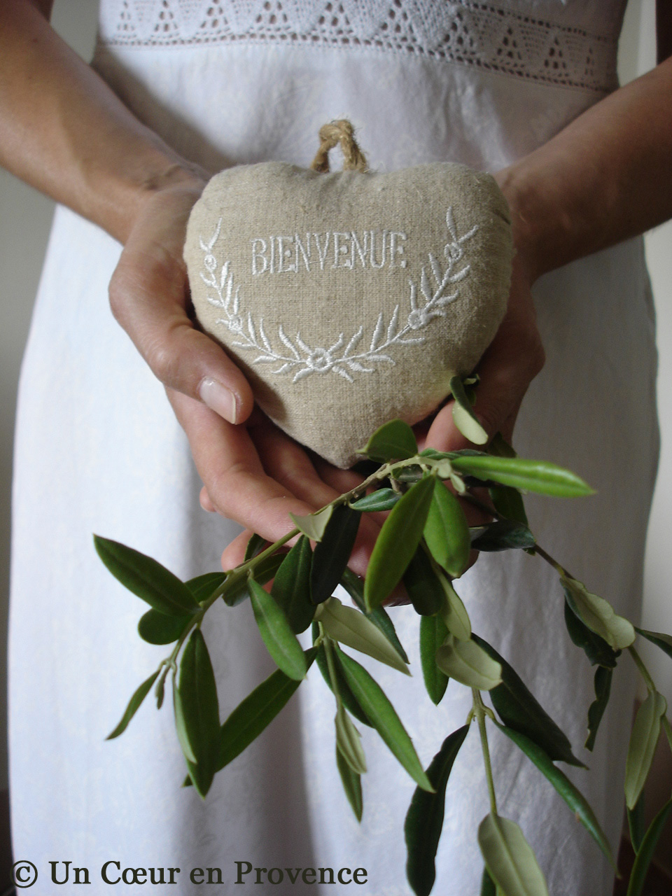 Linen heart and branche of olive tree