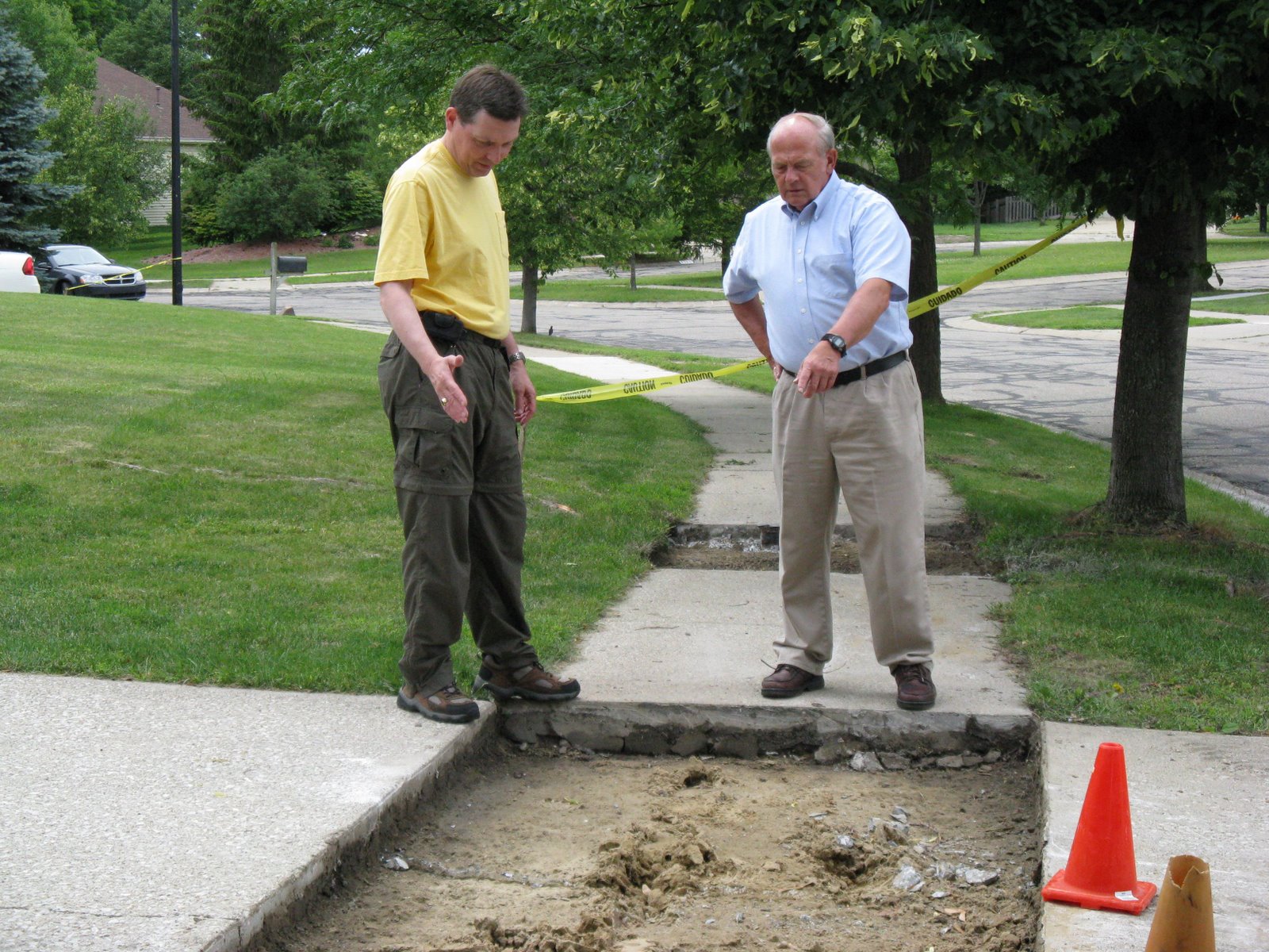 Tony Derezinski and Councilman Steve Rapundalo view sidewalk restoration