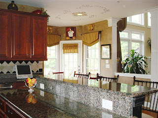 Kitchen includes granite countertops, work desk and center island. Includes view to breakfast nook