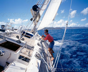 [man-standing-on-edge-of-sailboat-~-73118864.jpg]