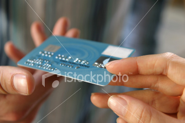 [ist2_4652423_hand_passing_a_payment_card_n_b_mocked_up_details.jpg]