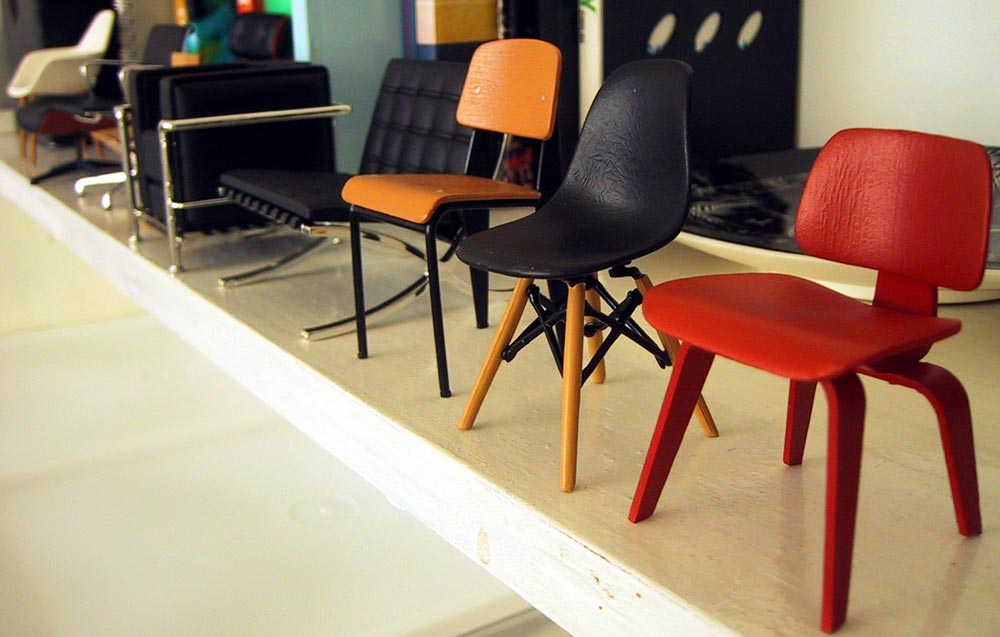 Row of modern miniature designer chairs.