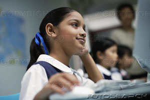 [girl-at-computer-in-classroom-with-other-students-in-background-~-pe0059454.jpg]