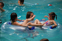 Mom and the girls on the tube in the wave pool