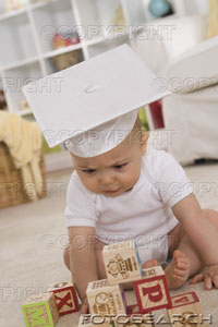 [baby-wearing-graduation-cap-playing-with-blocks-~-ks121721.jpg]
