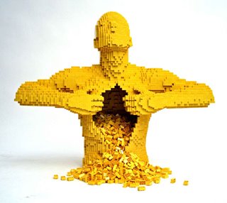 Yellow male figure made of Legos, ripping his own chest open; Legos spill out