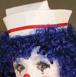 Old-fashioned nurse's hat worn by a clown with blue hair