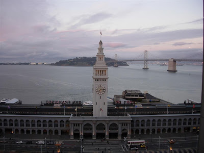 a clock tower on a building with a large body of water