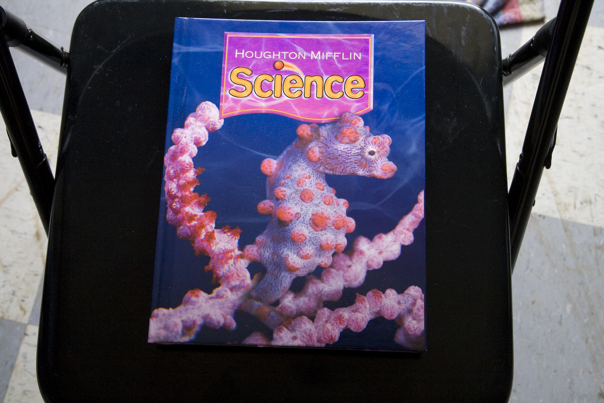 Science textbook on a chair, cover has a seahorse