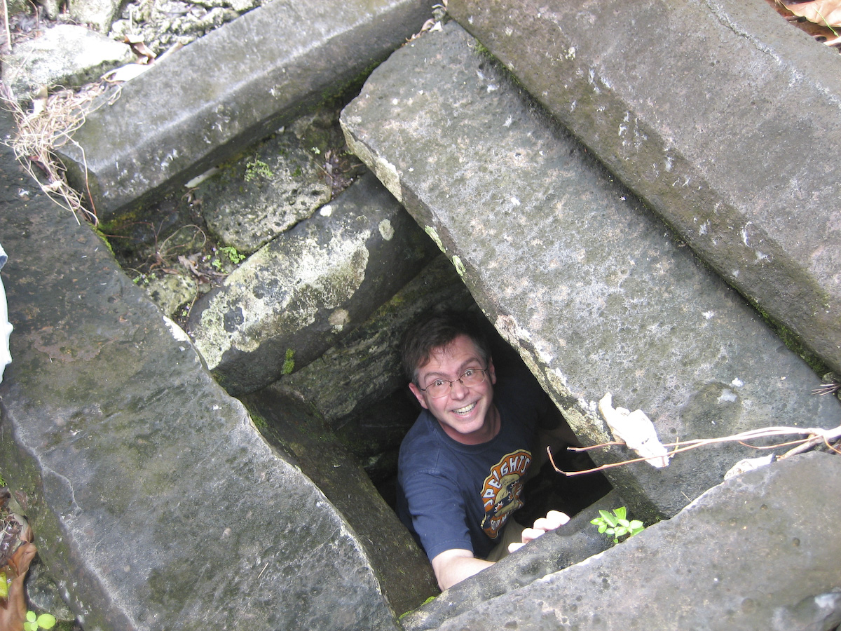 Jim looking up from down inside rectangular stone pit