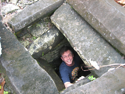 Jim looking up from down inside rectangular stone pit