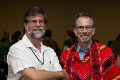 Larry Goldberg and Daniel Ben Horin in a red latin american woven poncho
