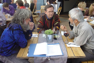 Kevin Carey, Jim Fruchterman, Hiroshi Kawamura seated at a wooden table with papers