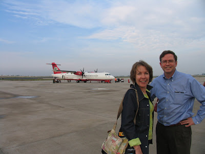 airport tarmac, Air Deccan prop plane in background, Virginia and Jim Fruchterman