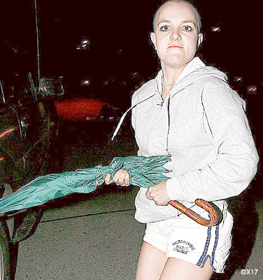 britney spears bald umbrella. Bald Britney Spears using green umbrella to attack in the car.