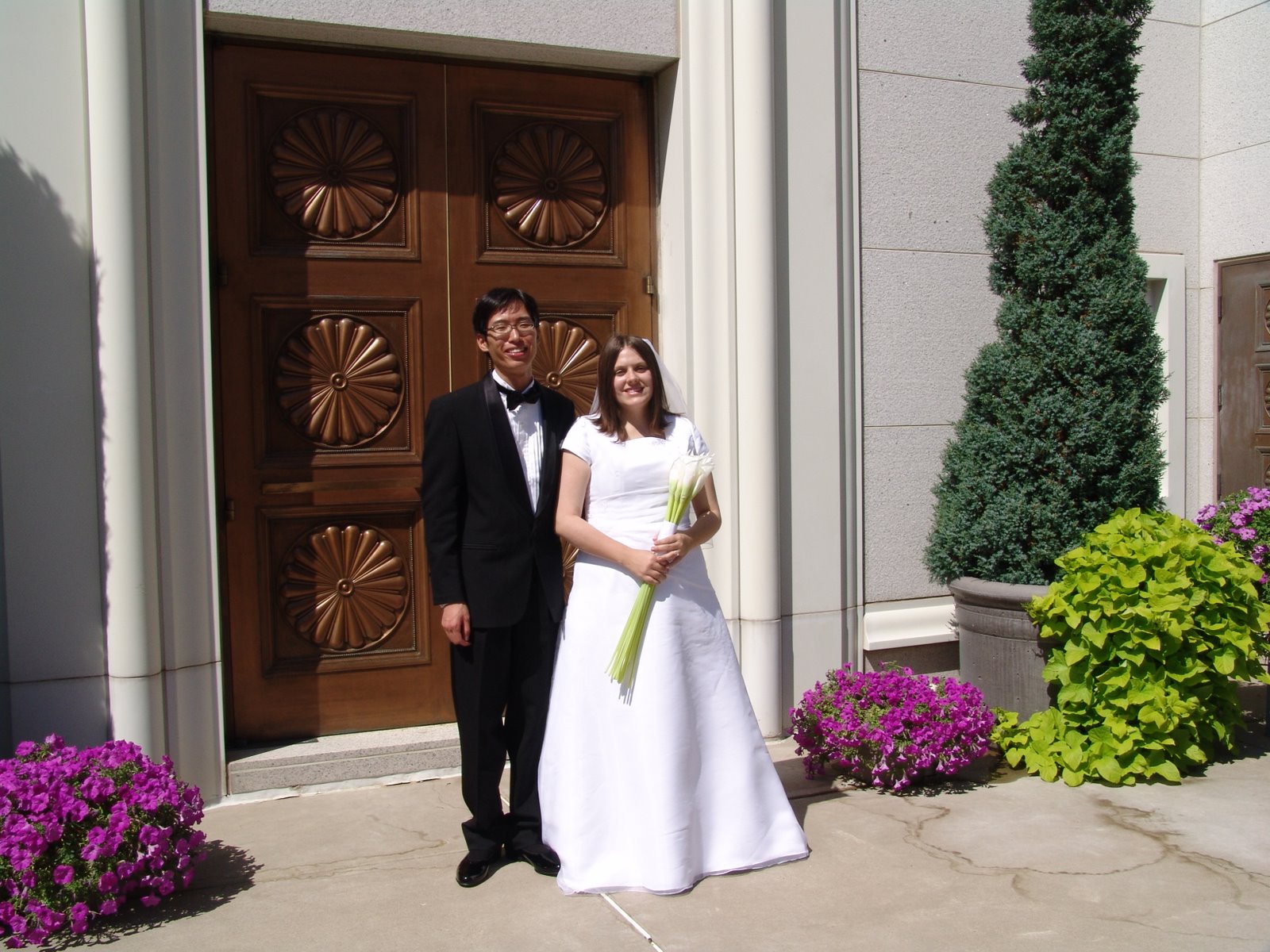 [bride+w+groom+at+temple+door.jpg]