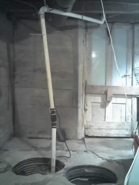 This is not an unusual configuration for a sump pump.  It is rather pathetic in the design area.  The water runs continiously uphill to the exit fitting.  I need to repipe it to head up the wall on the left, then across and then down to the exit fitting.  That way, I believe it will not freeze when it gets real cold outside like it did last year.  The cold ran down the pipe and conducted the temp change to freeze the water.  The wall could also be consided a heat sink in the fact that it didn't get cold.