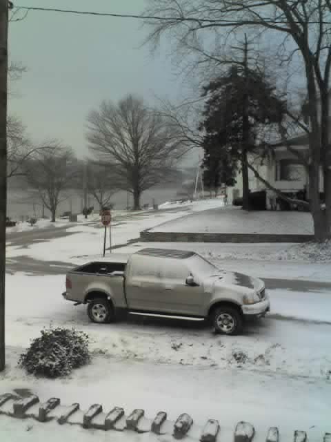 A view up the street (north west) showing the snow on the ground and on the pick-up.