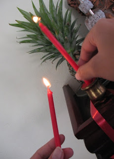 Putting candles on the Buddha shelf