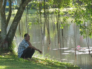 Man on the phone next to lake in Phuket Town