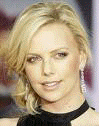 head shot of Charlize Theron in a black dress